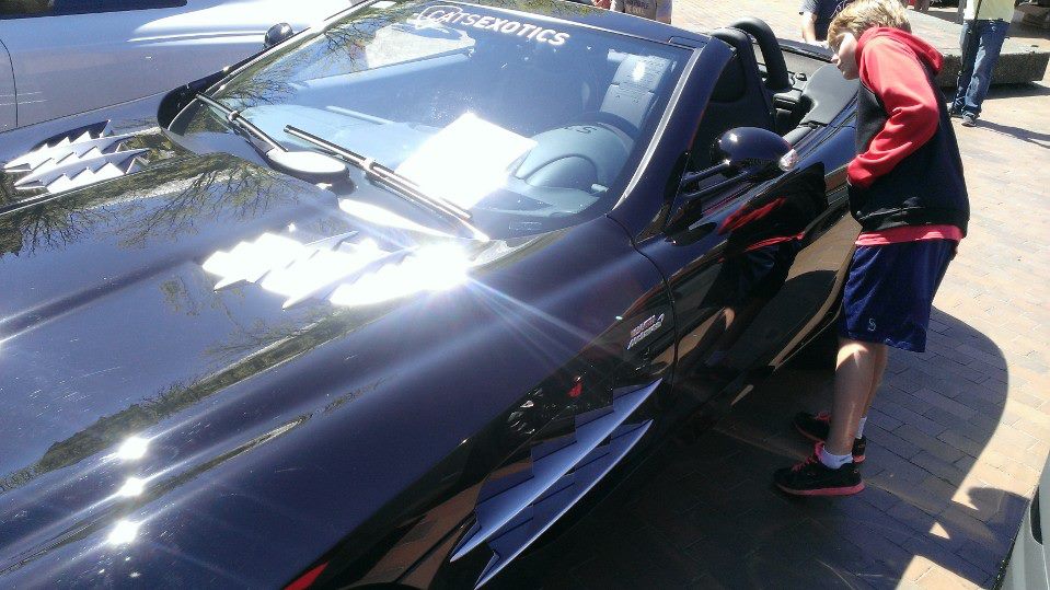 Luke admiring a McLaren